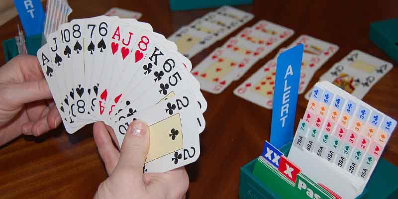 Strategies to Optimize Scores in Card Games Bridge